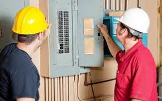 Electricians by fuse box